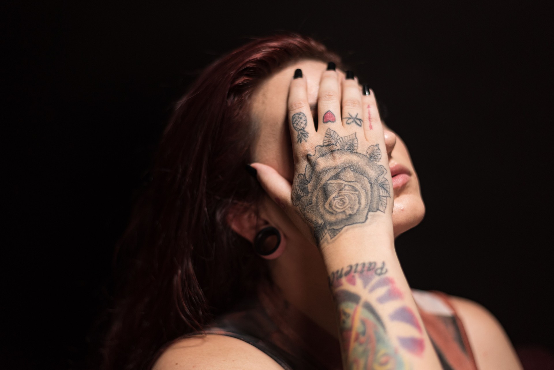 Portrait of young LGBTQ woman with tattoos.